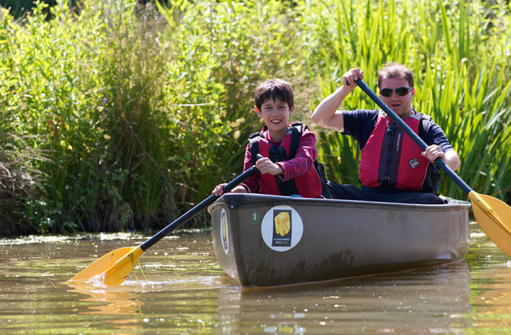 Picture of father and son on a canoe at WWT Martin Mere